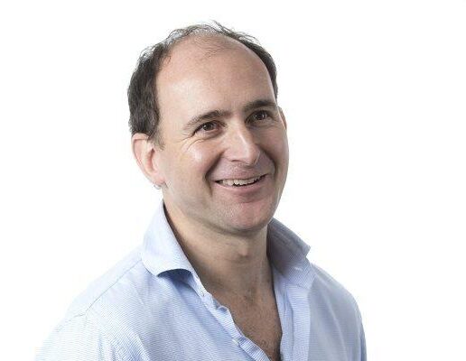 David Morel smiling and looking away from the camera
