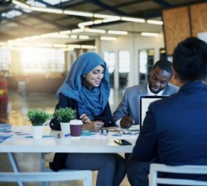 Three people sitting in an office