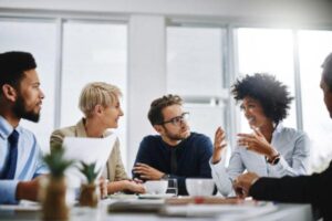 A diverse group of business colleagues sitting around together and discussing core business decisions.