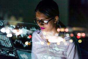 A female engineer is looking at information on an interface, thinking about how technology is affecting the future of work.