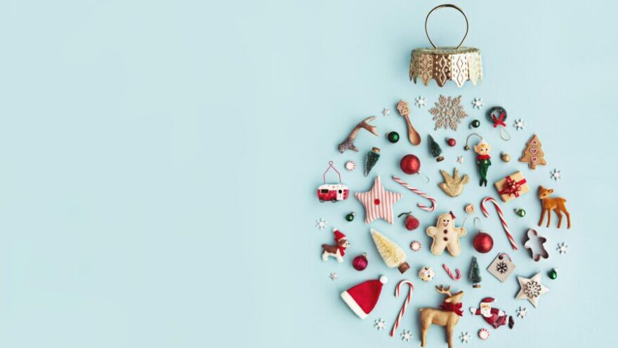 A Christmas ornament made up of tiny little symbols of Christmas, including a santa hat, candy canes, and Christmas trees.