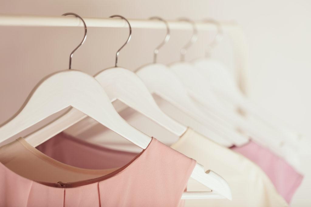 Women's clothing in pink tones on a white hanger.