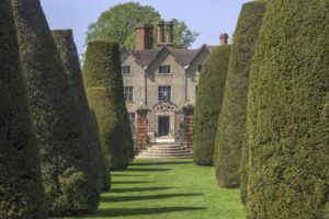 Country house with hedges leading up to the front door.