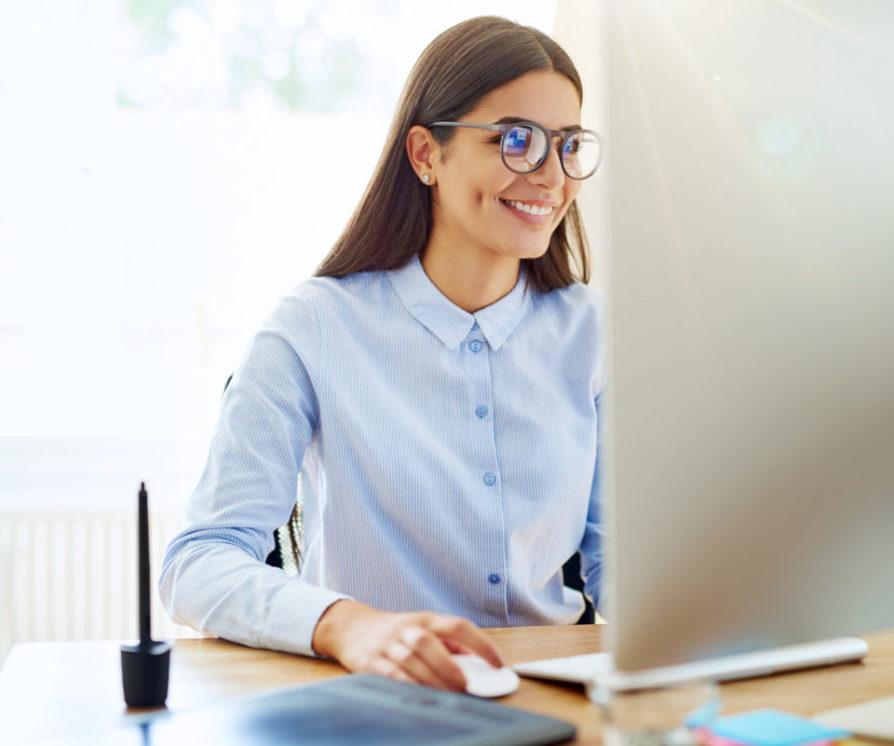 Smiling woman working on computer