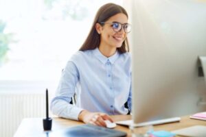 Smiling woman working on computer