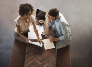 Female and male employees have a meeting regarding business support staff hiring