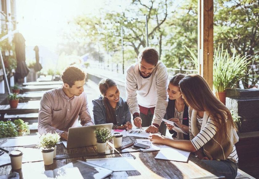 Shot of a group of colleagues having a meeting at a cafe