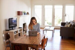 Woman sitting at her desk in her house