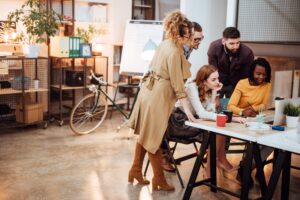 Group of people surrounding a computer