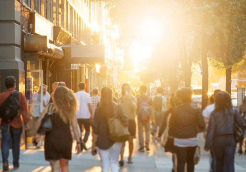Crowd of people walking down sidewalk in Manhattan, New York City