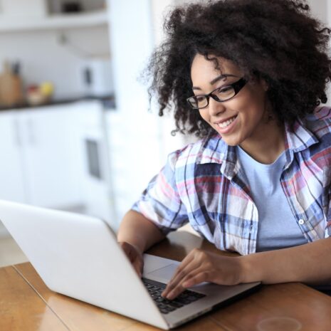 Woman with eyeglasses using laptop at home