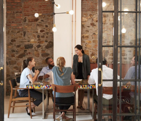 Female boss addressing business team in a meeting room