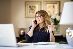 Personal assistant talking on the phone while sitting at her desk