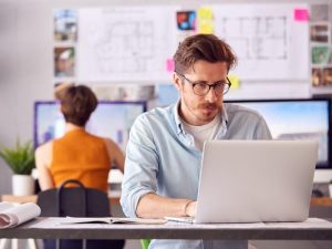 Man in office working on laptop