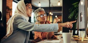 Two Dubai businesswomen working together at a computer