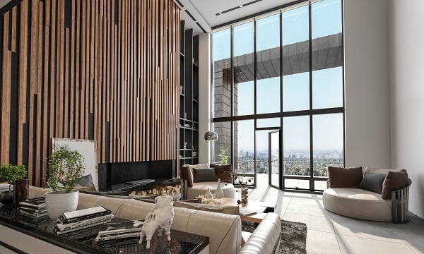 Interior of a luxury modern property with large windows looking out on a sunny day.