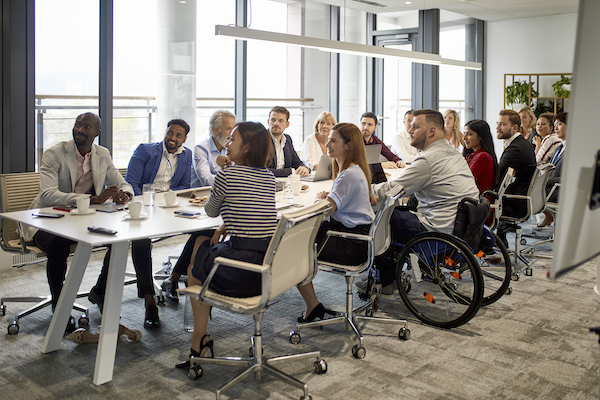 Office workers sitting around a table.