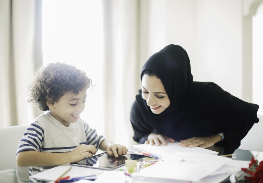 Arabic women oversees child's homework
