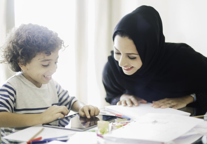 Arabic woman oversees child's homework