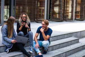 A photo of three employees collaborating in an outside meeting