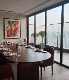 A photo of a private room dining layout with skyline views of the city