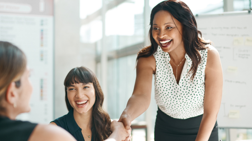 Finance professionals around a meeting desk interviewing