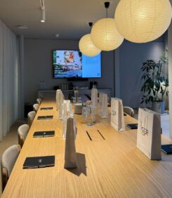 long table with branded white bags and notebooks