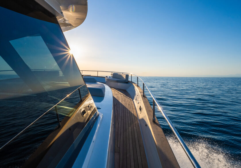 Luxury yacht moving in sea against blue sky.
