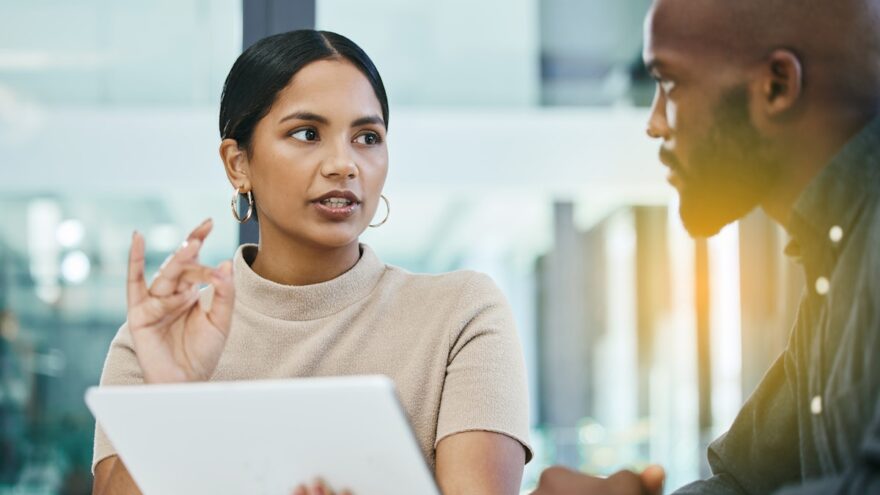 Two colleagues in meeting, discussing documents